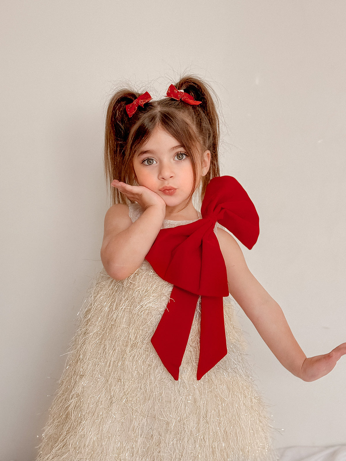 Gold Jingle Belle tulle party dress with an oversized velvet shoulder bow and sleeveless bodice