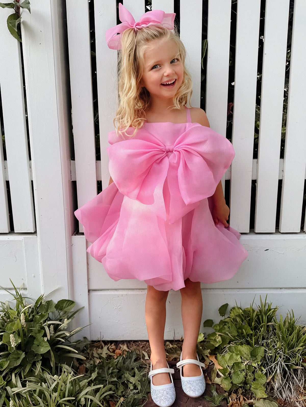 Hot Pink organza party dress, straight neck, sleeveless with off-shoulder straps, oversized organza bow, puff organza skirt, above knee length, for birthday and party.