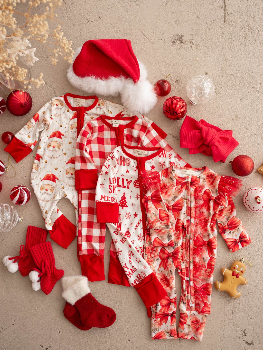 All I Wish Christmas baby onesies laid out together including the Dear Santa print - Before & Ever Kids