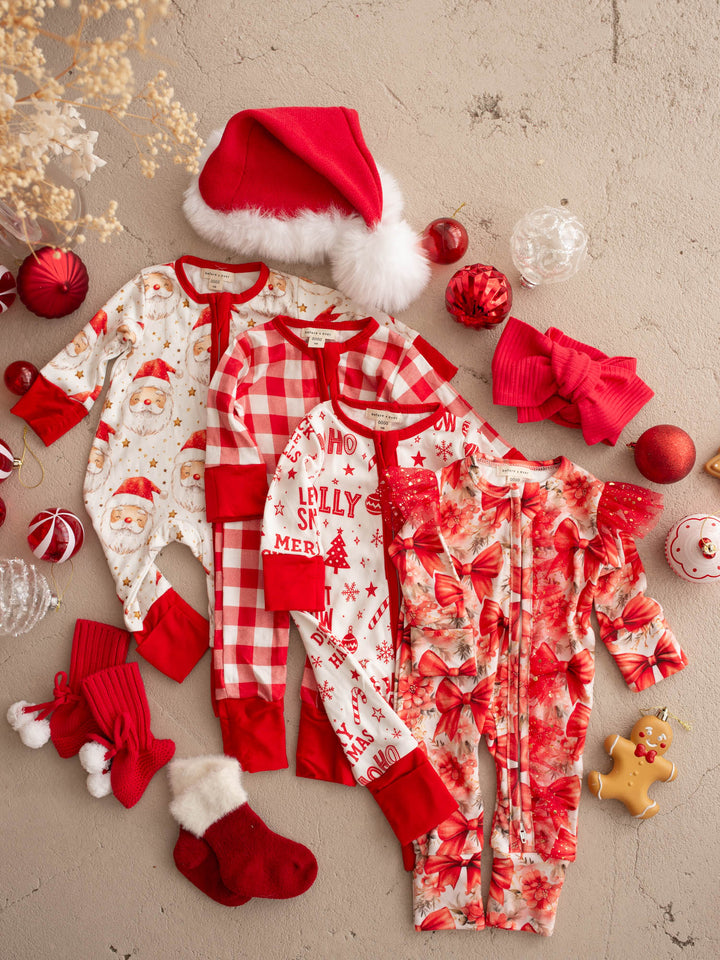 All I Wish Christmas baby onesies laid out together including the Dear Santa print - Before & Ever Kids