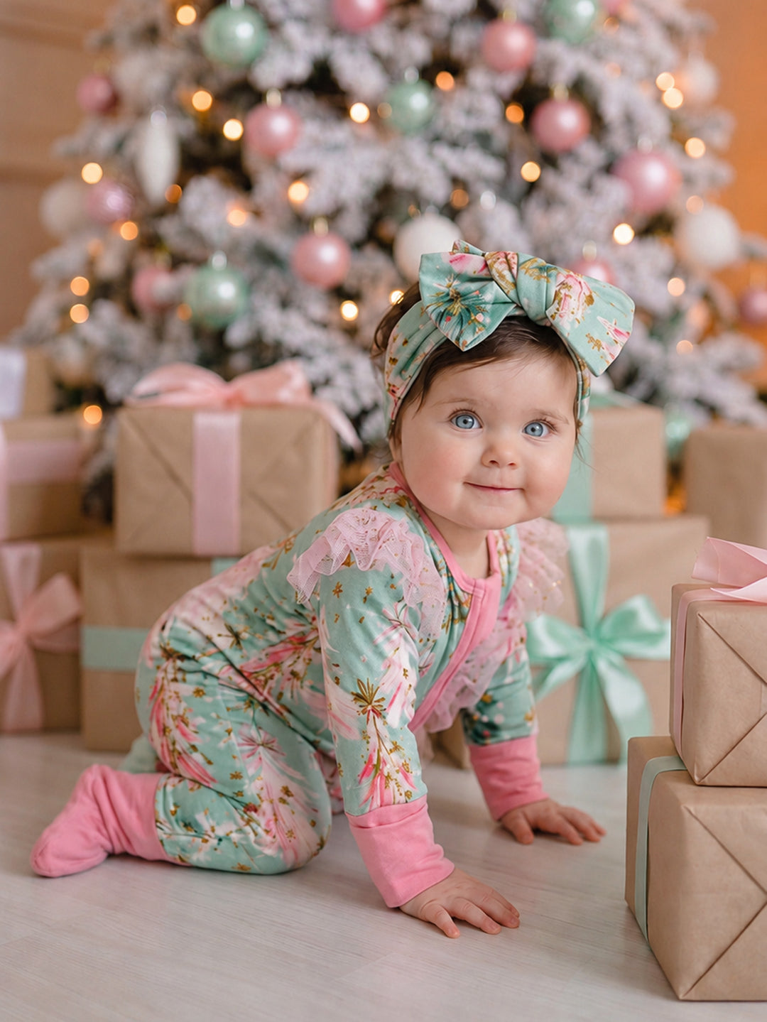All I Wish Mint Pine baby onesie with pink cuffs and feet, worn by a crawling baby girl in the matching topknot headwrap - Before & Ever Kids