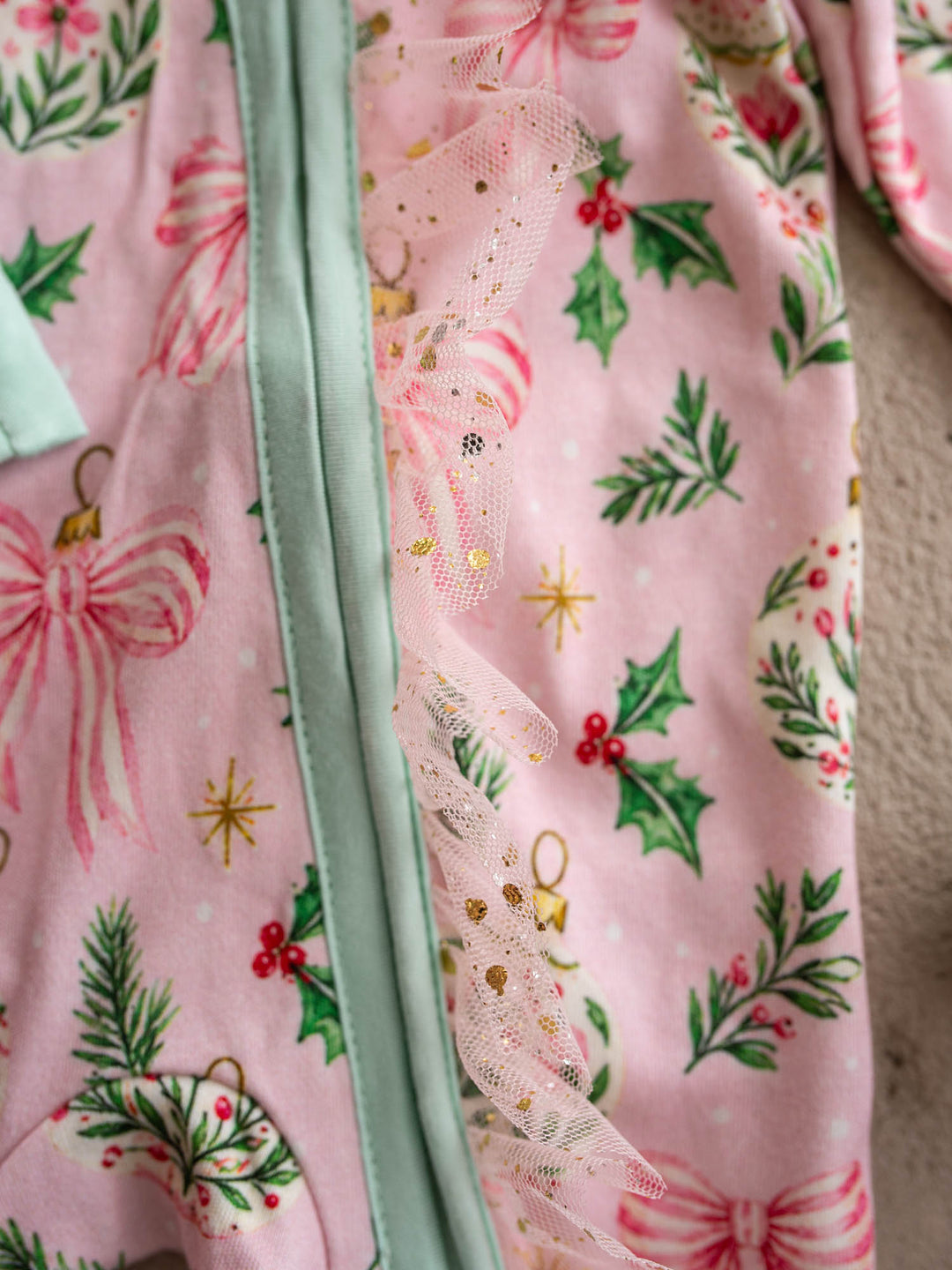 All I Wish Pink Holly baby onesie, holly, gold baubles and bows on pink with mint cuffs - Before & Ever Kids