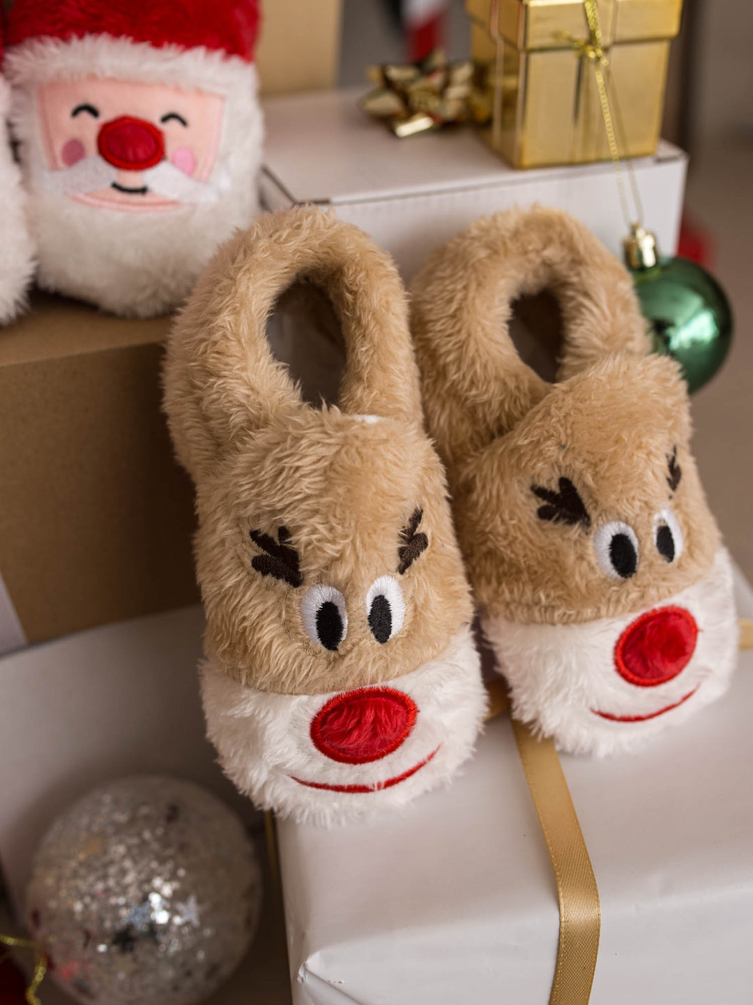Baby Rudolph Slippers tan reindeer slippers with antlers and red nose, on a present - Before & Ever Kids