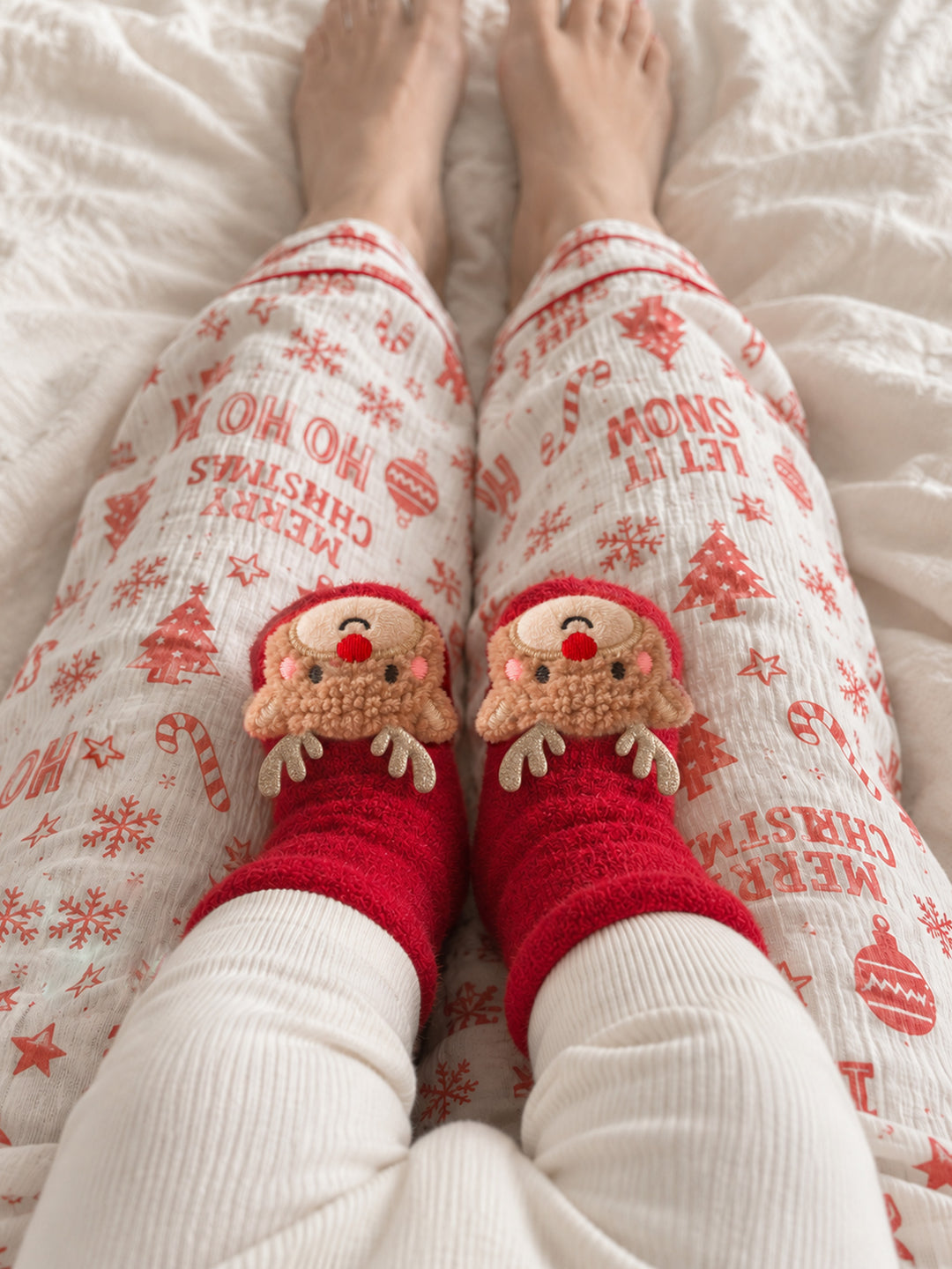 Baby Rudolph red fluffy baby socks with gold glitter antlers and a red nose, worn by a baby resting on mum's lap in matching Christmas pyjamas - Before & Ever Kids
