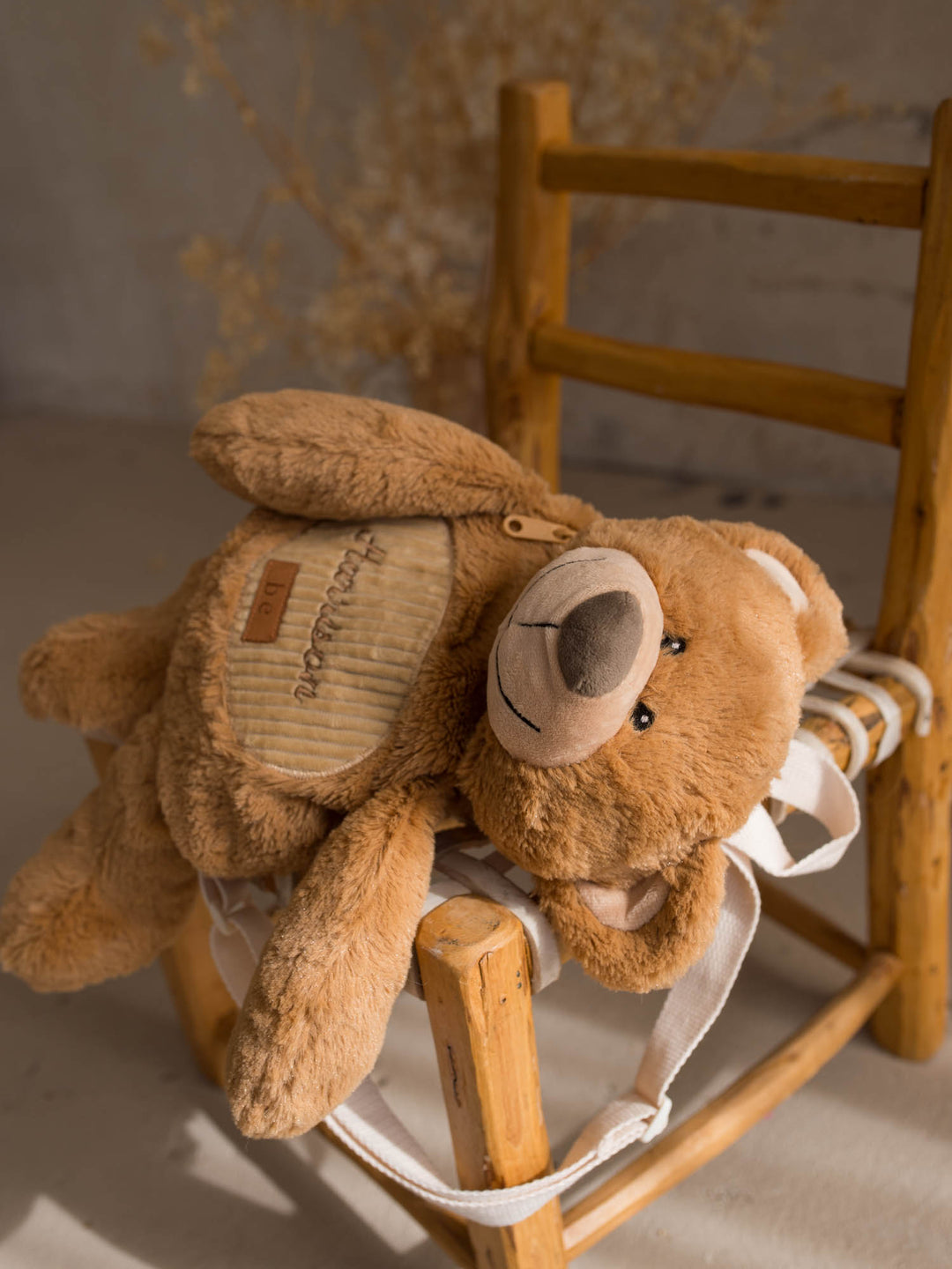 Beau the Bear personalised plush backpack for kids, bear sidekick backpack resting on a chair - Before & Ever Kids