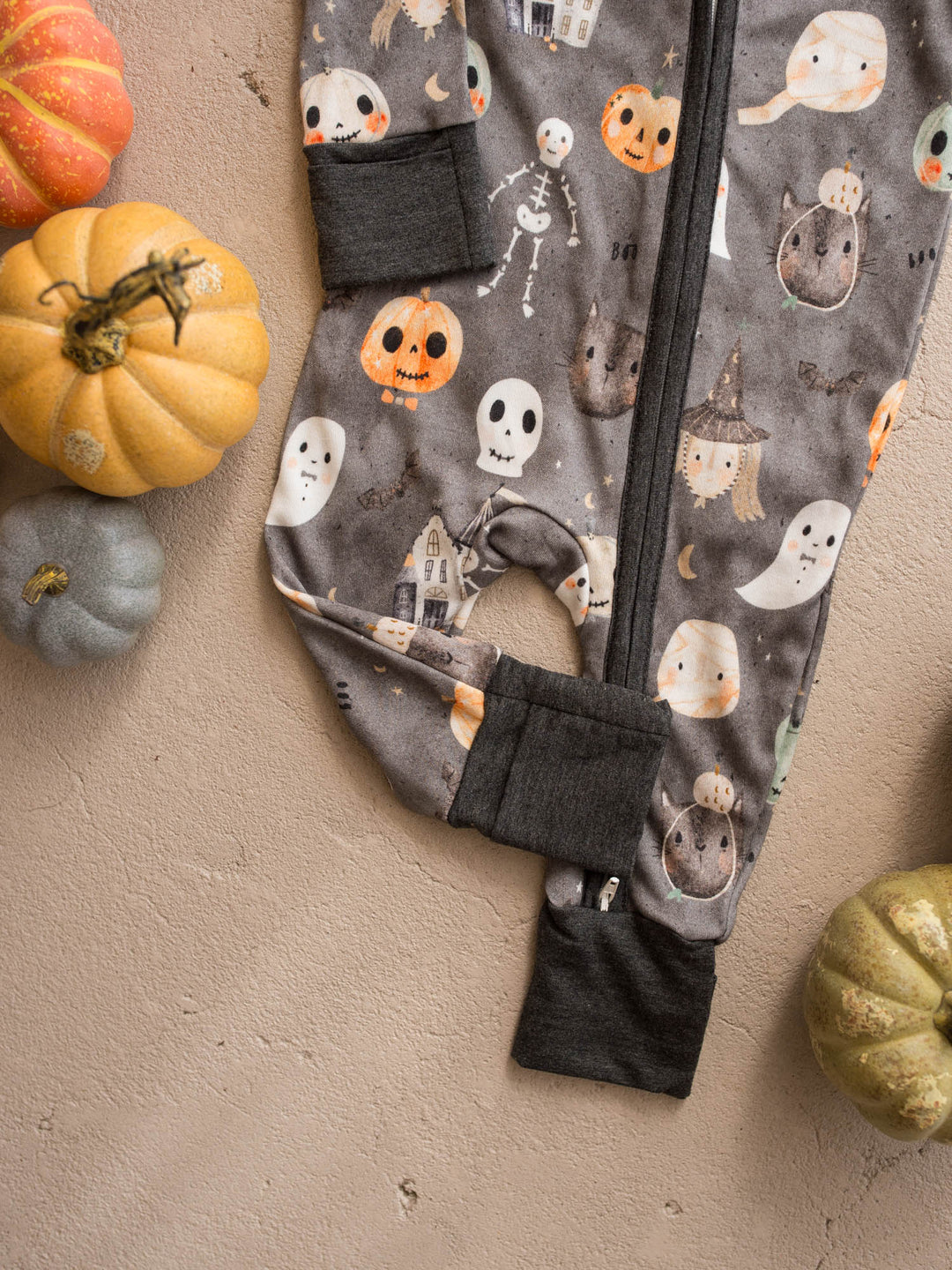 Boo Crew onesie detail showing charcoal cuffs, two-way zipper and skeleton print - Before & Ever Kids