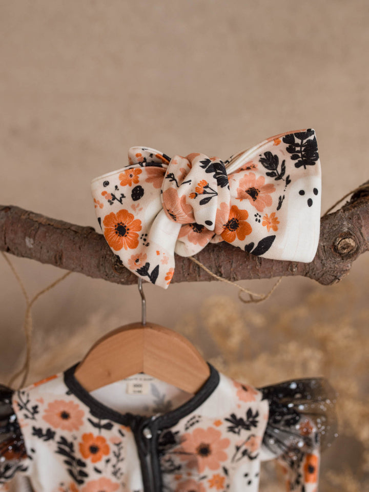 Boo-quet floral topknot headwrap above its matching Halloween baby onesie - Before & Ever Kids