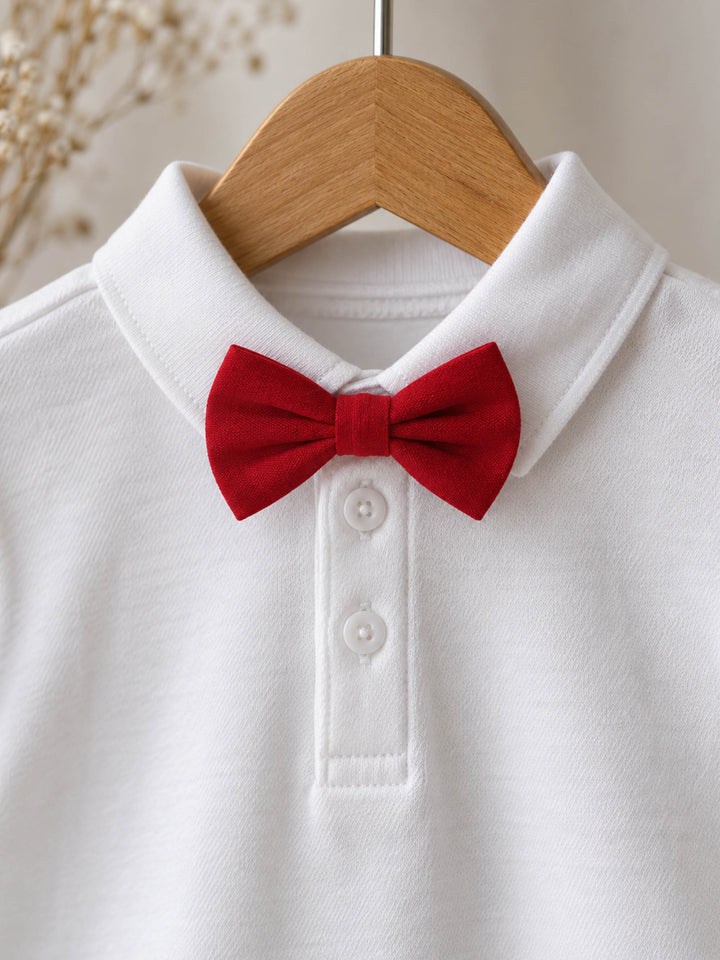Everyday Cotton Polo, white long sleeve cotton polo, close up of the collar and buttons on a hanger, styled with a red velvet bow tie (sold separately) - Before & Ever Kids