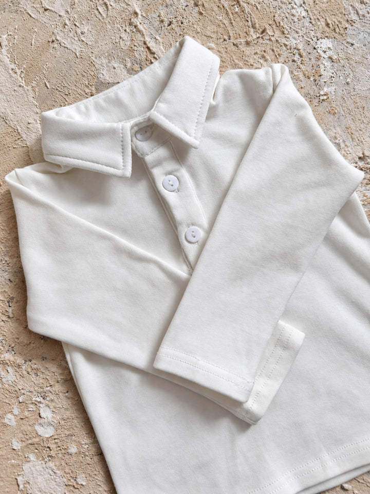 Everyday Cotton Polo, white long sleeve cotton polo, folded, showing the collar and long sleeve - Before & Ever Kids