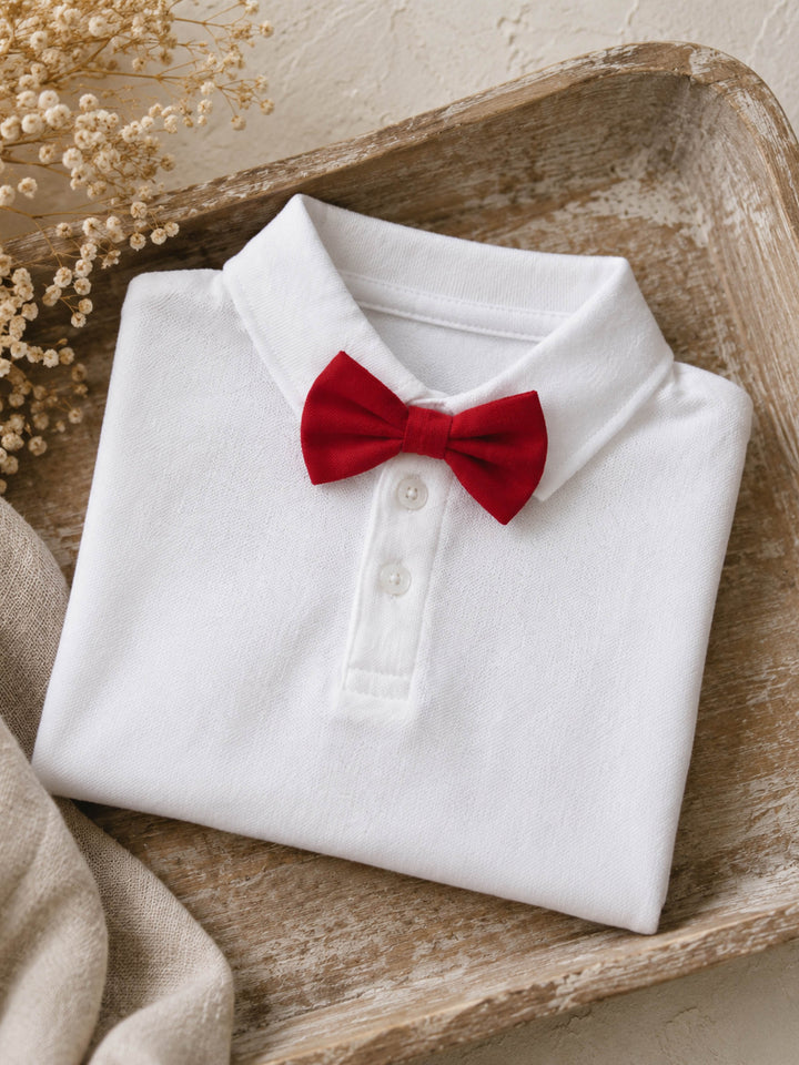 Everyday Cotton Polo, white long sleeve cotton polo, folded in a wooden tray, styled with a red velvet bow tie (sold separately) - Before & Ever Kids