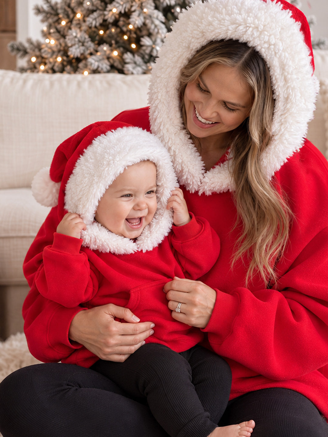 Ho Ho Hoodie red kids hoodie with the Santa hat hood up on a laughing baby, close up of the white fluffy trim - Before & Ever Kids