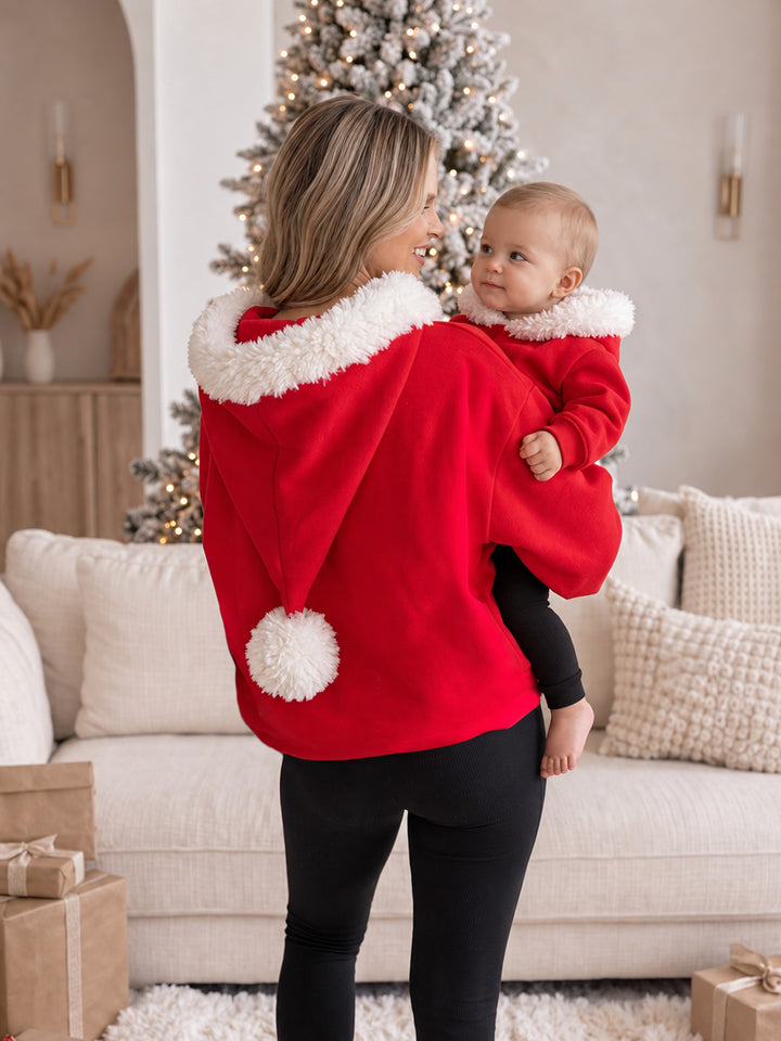 Ho Ho Hoodie red adult hoodie full length back view with the pom-pom hood, a mum holding a baby in the matching hoodie - Before & Ever Kids