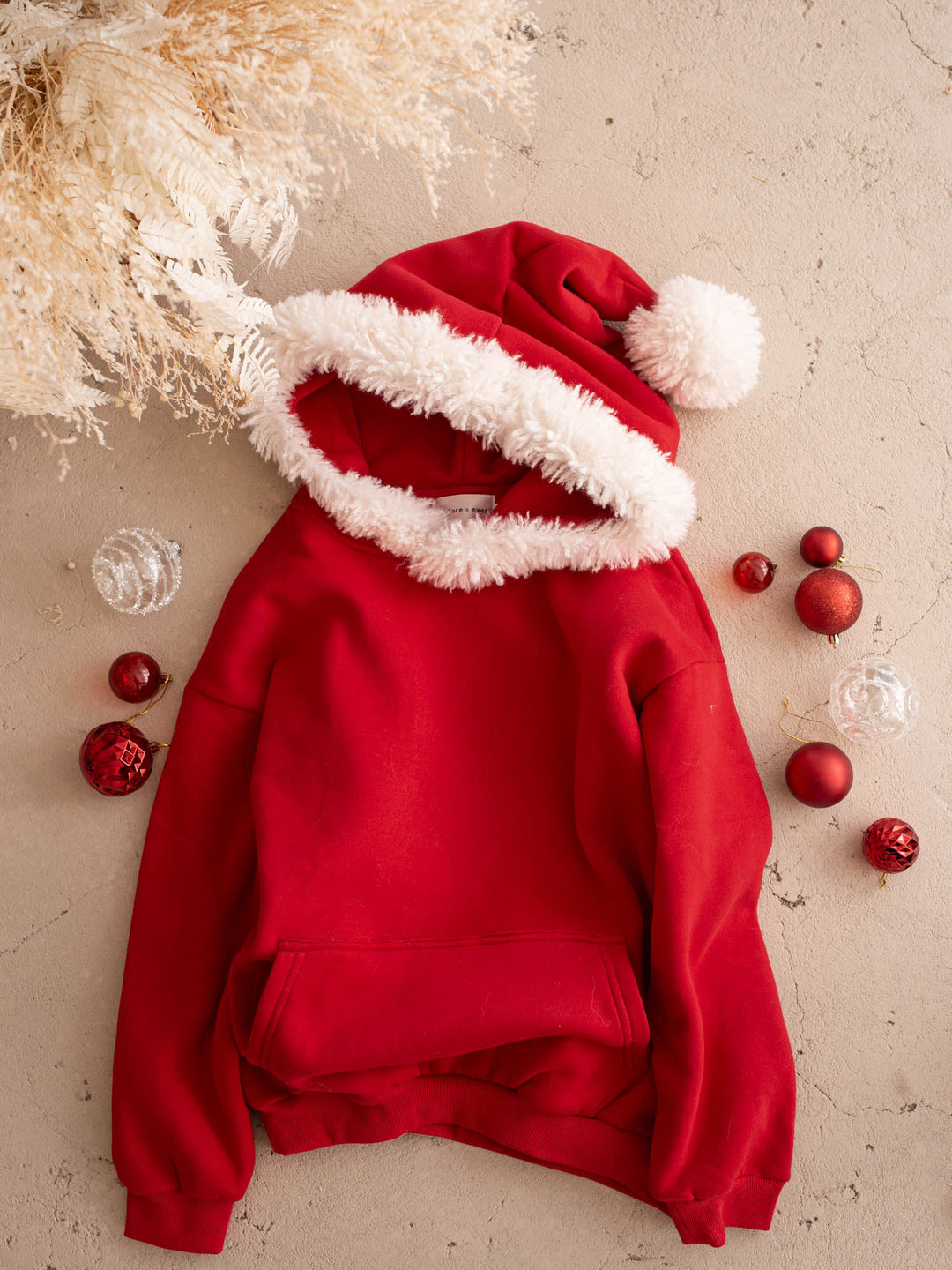 Ho Ho Hoodie red adult hoodie laid flat with the Santa hat hood up - Before & Ever Kids
