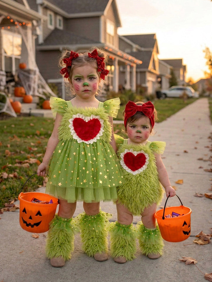 Little Grump green faux-fur romper on baby with big sister in matching green tulle dress holding pumpkin buckets - Before & Ever Kids