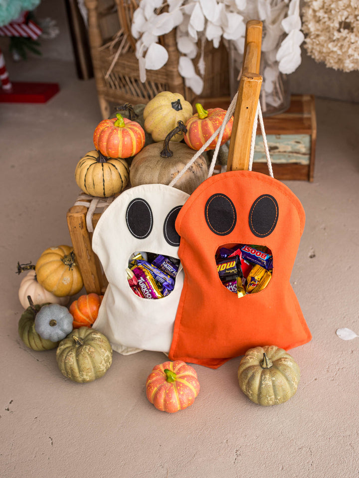 Little Gulp Ghost Treat Bag in cream and orange, both filled with Halloween sweets - Before & Ever Kids