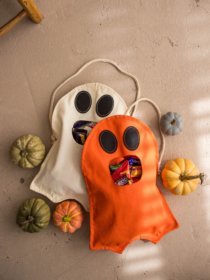 Little Gulp Ghost Treat Bag in cream and orange laid flat with pumpkins - Before & Ever Kids