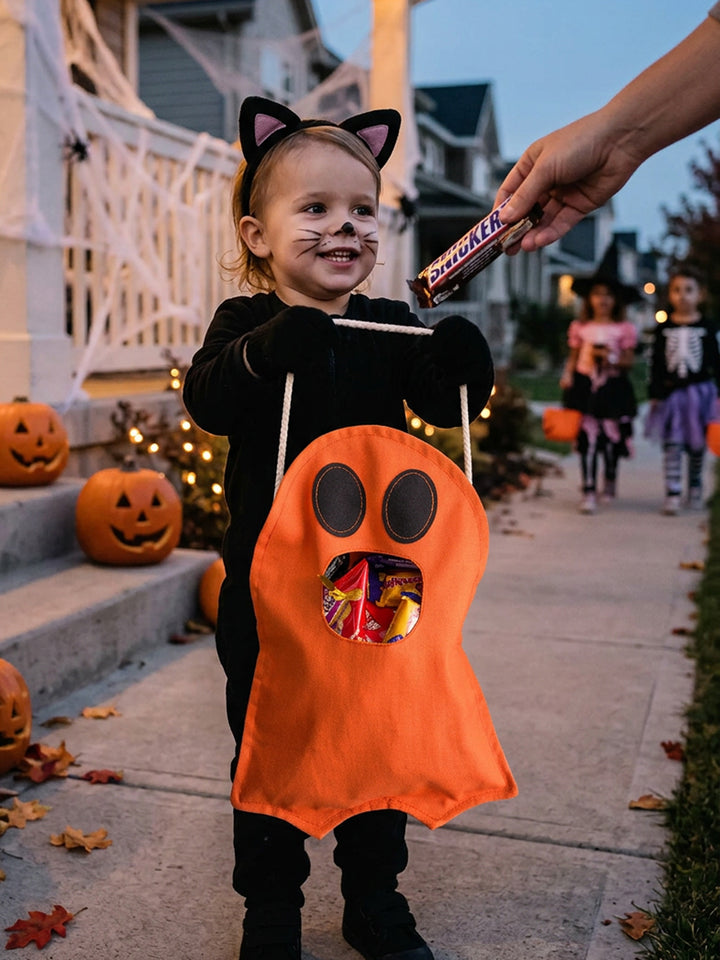 Child collecting sweets into the Little Gulp Ghost Treat Bag in orange - Before & Ever Kids