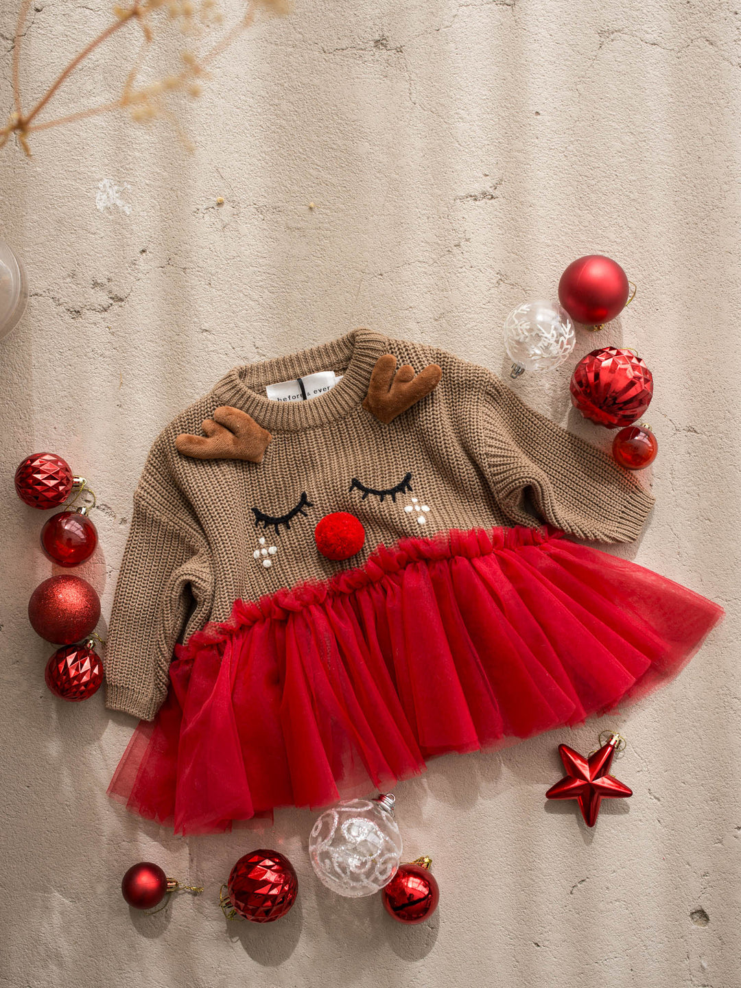 Little Reindeer Sweater brown and red front view, camel knit sweater with an embroidered sleeping reindeer face, felt antlers and a red tulle frill across the front - Before & Ever Kids