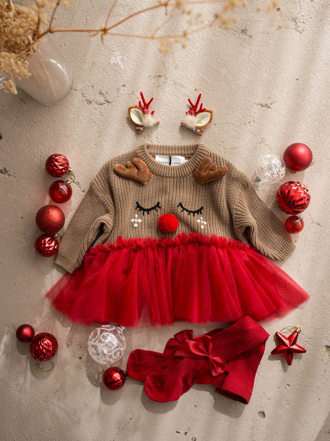 Little Reindeer Sweater brown and red camel knit sweater with an embroidered sleeping reindeer face, felt antlers and a red tulle frill across the front - Before & Ever Kids