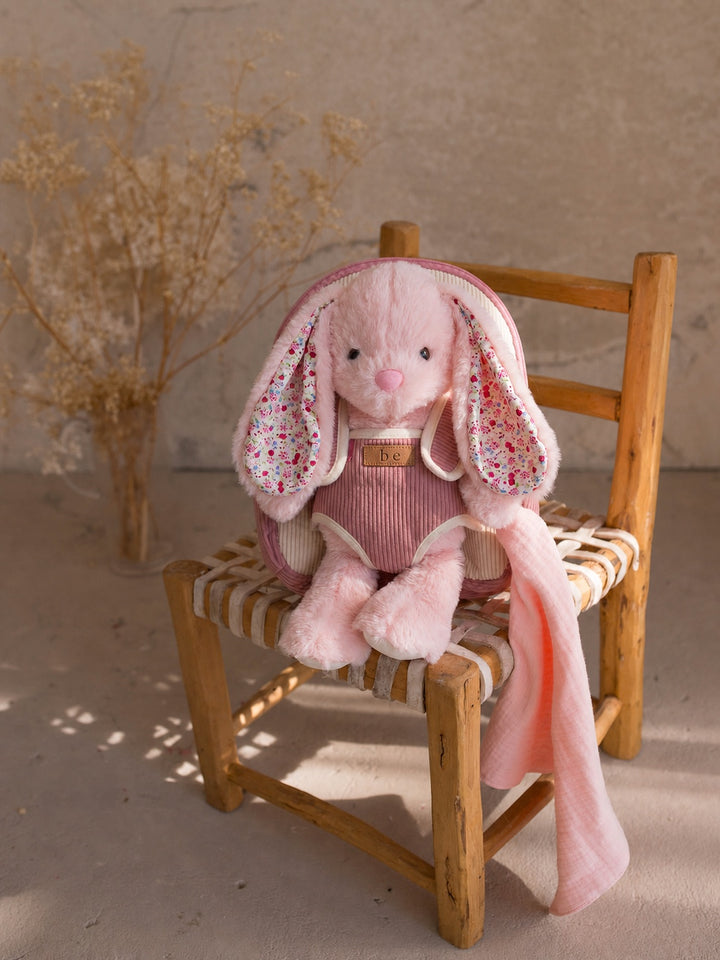 Macie the Bunny plush backpack for kids, bunny sitting on a chair with the backpack - Before & Ever Kids