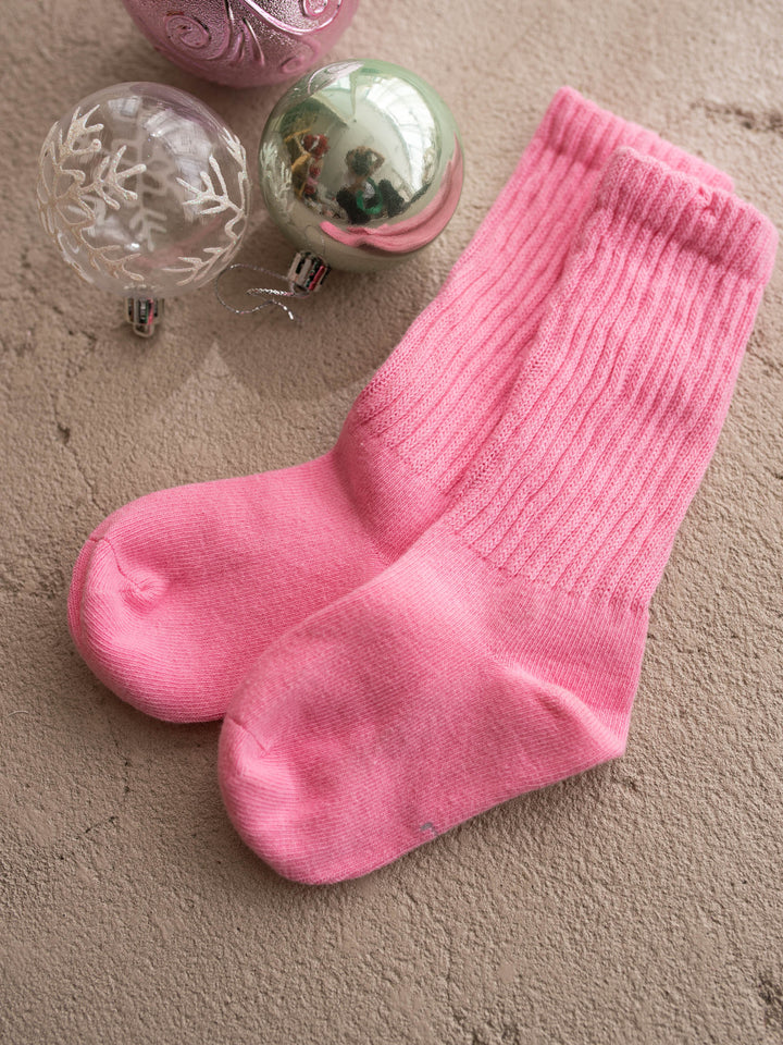 Bubblegum pink ribbed knit socks for babies and girls, full pair shown flat