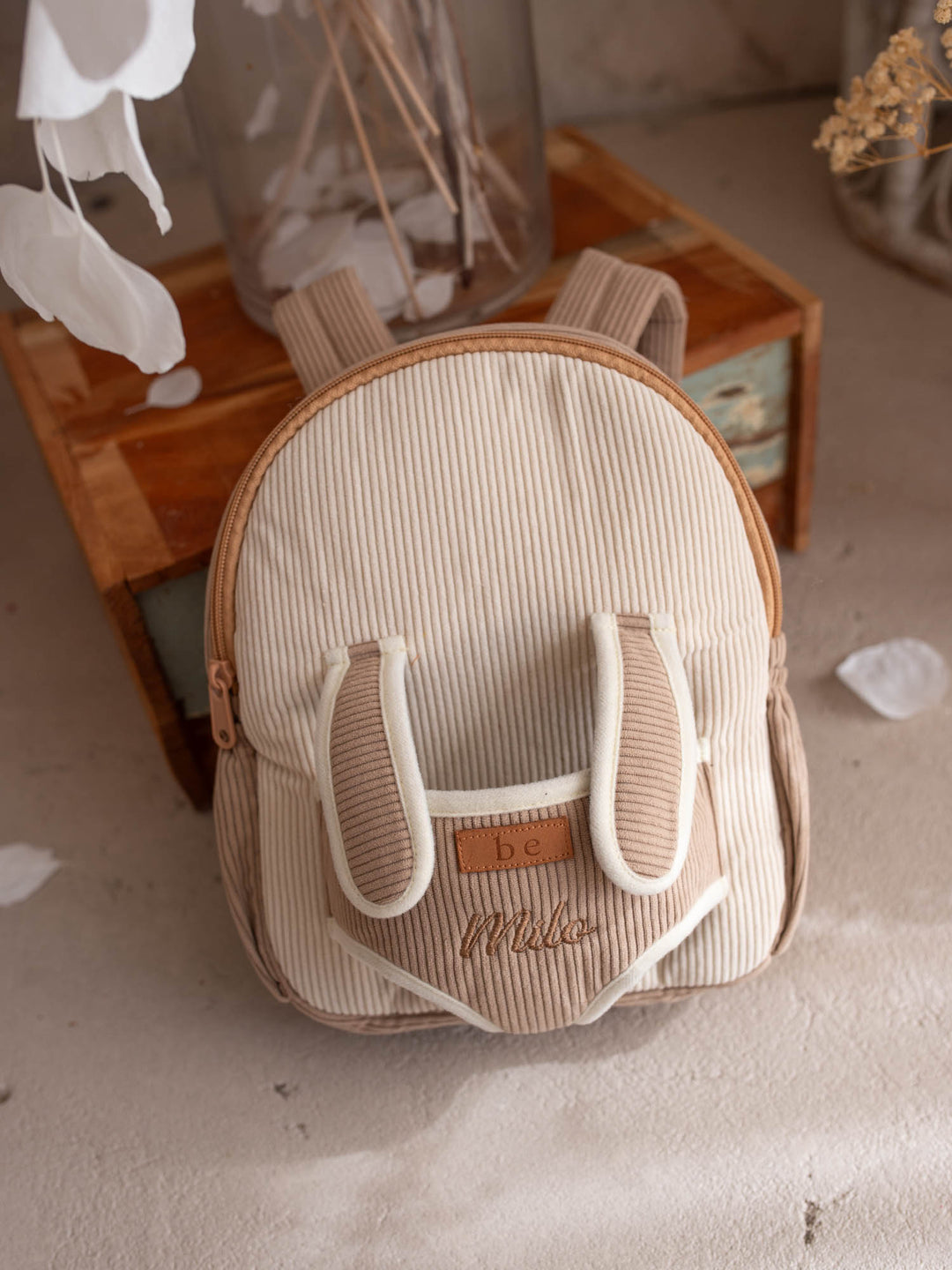 Milo the Puppy personalised Little BFF Companion Backpack, front view with the embroidered name on the corduroy panel