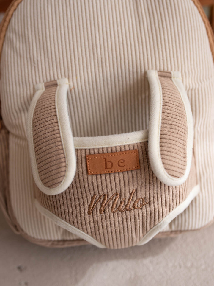 Milo the Puppy personalised Little BFF Companion Backpack, close up of the embroidered name on the corduroy panel