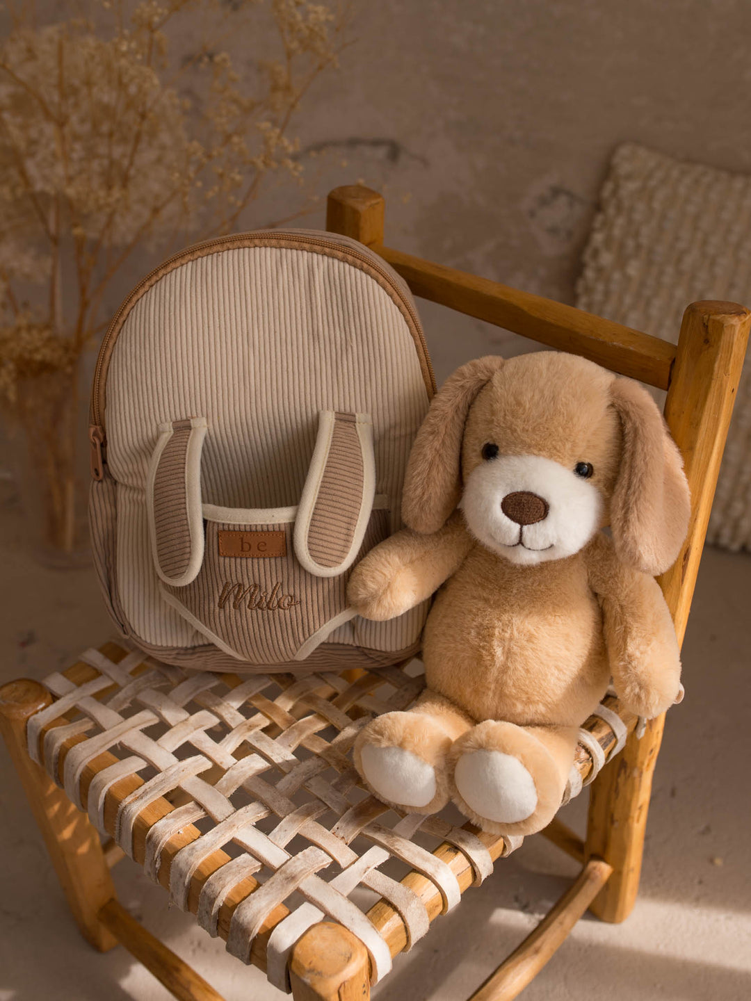 Milo the Puppy personalised plush backpack for kids, backpack with the puppy sitting beside it - Before & Ever Kids