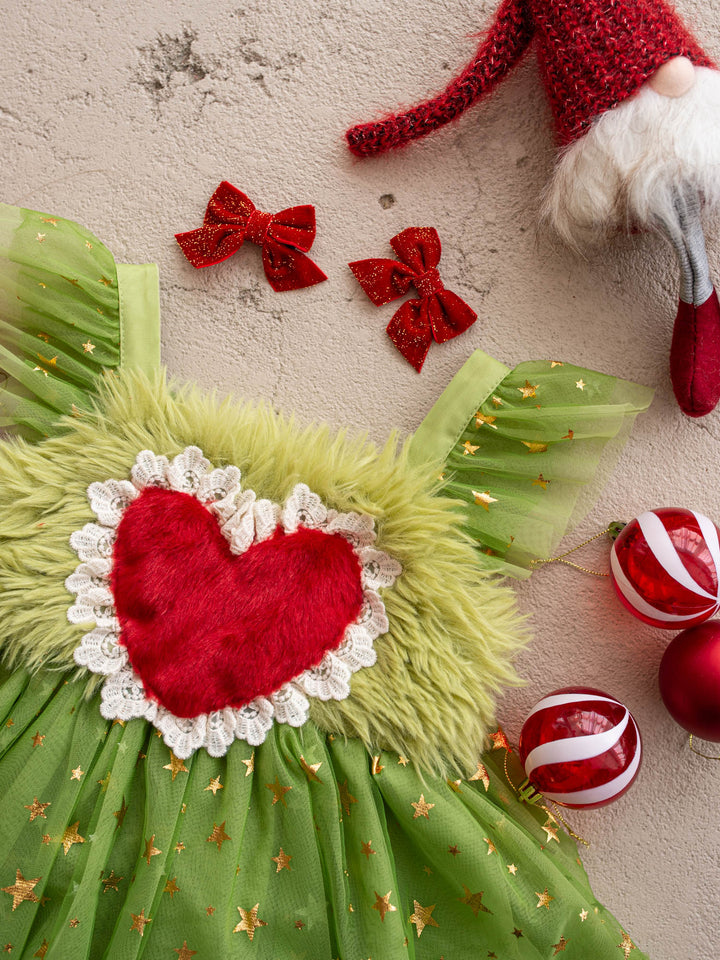Close-up of the red fur heart and lace trim on the Miss Grump green faux-fur Christmas dress - Before & Ever Kids