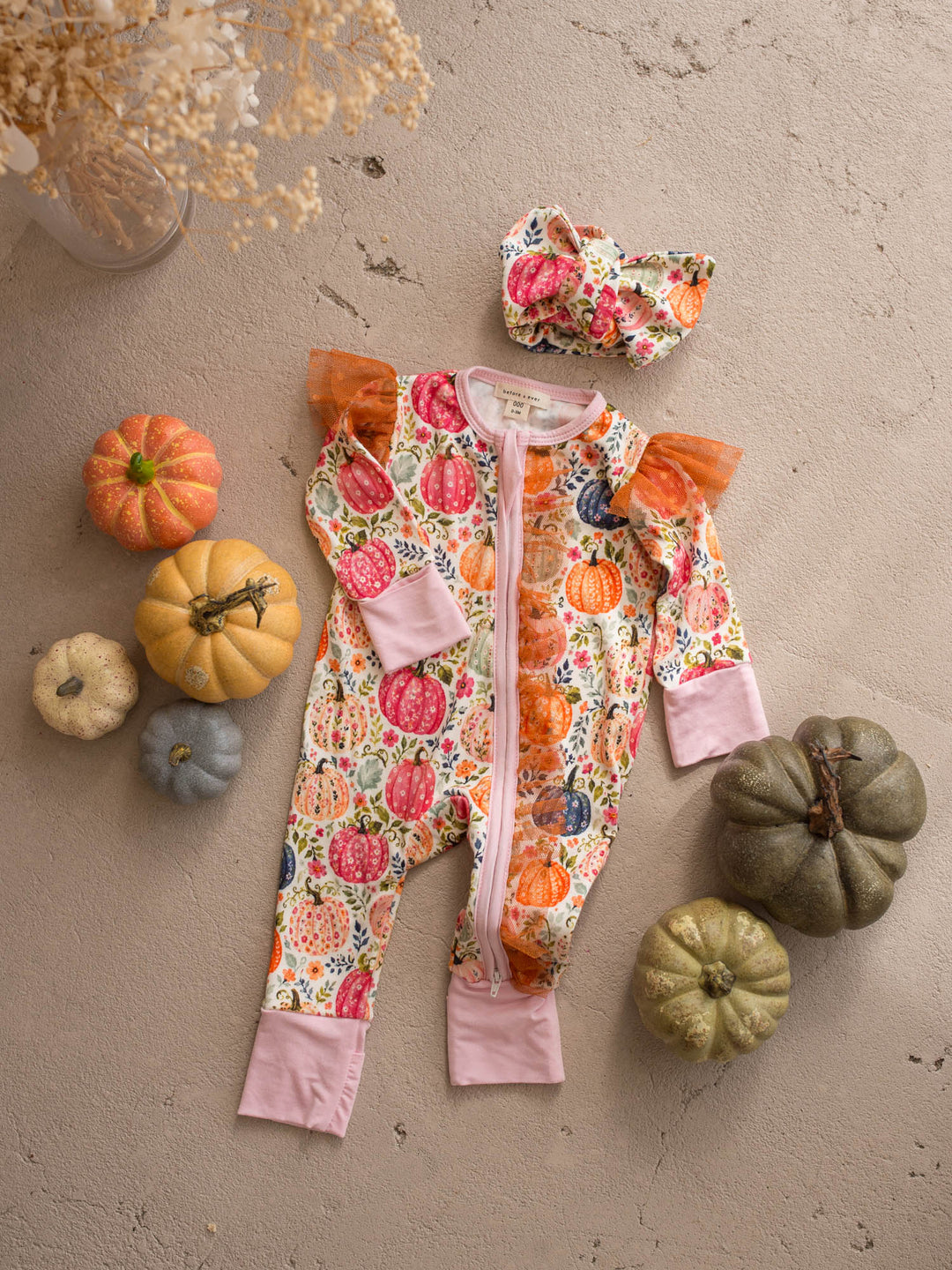 Patch Perfect topknot headwrap flat lay with the matching pumpkin baby onesie - Before & Ever Kids