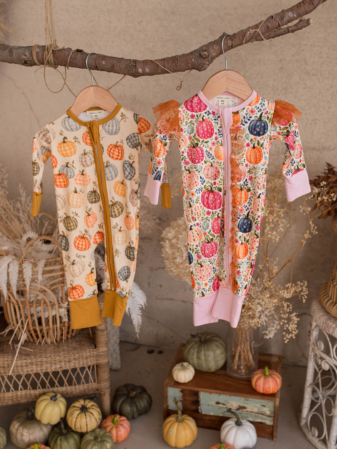Patch Ready and Patch Perfect matching pumpkin baby onesies hanging together - Before & Ever Kids