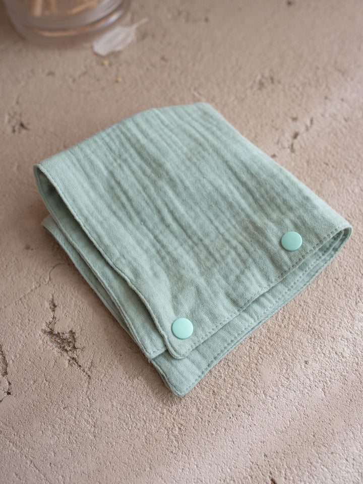Sage the Horse Little BFF Companion Backpack, the matching sage green muslin comforter that doubles as a bib or a bandana, folded