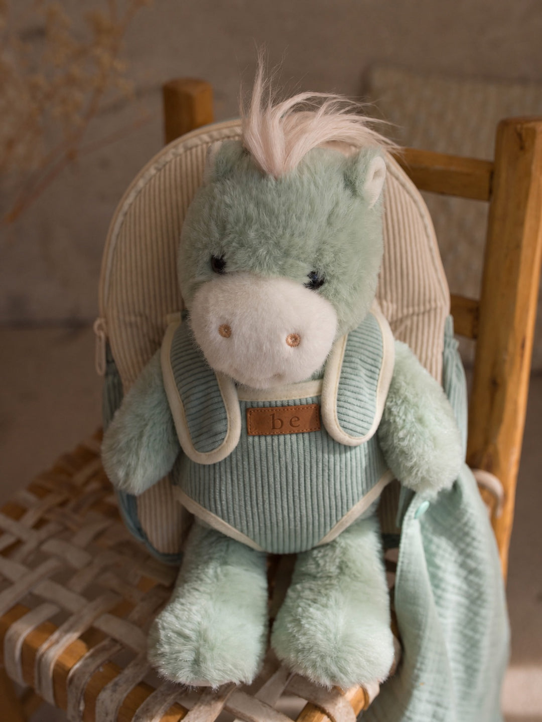 Sage the Horse plush backpack for kids, horse sitting in the backpack on a chair - Before & Ever Kids