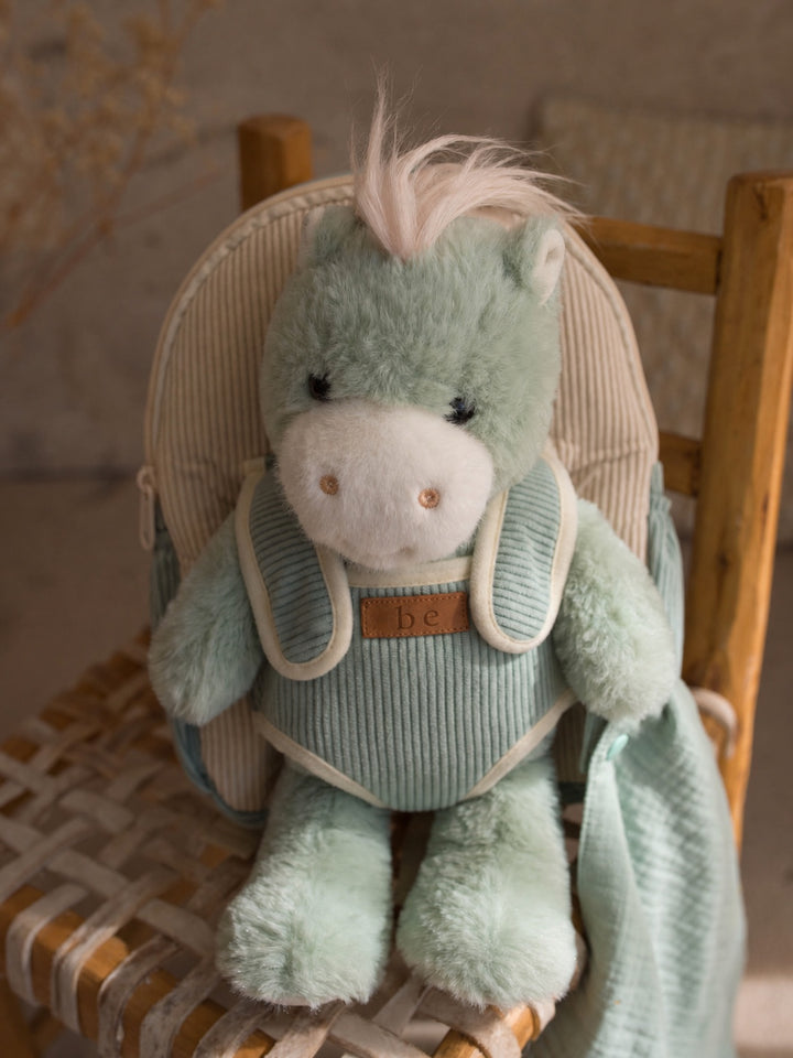 Sage the Horse plush backpack for kids, horse sitting in the backpack on a chair - Before & Ever Kids