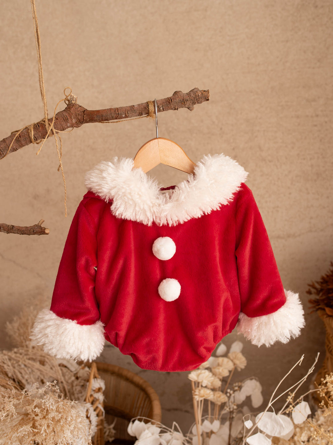 Santa Baby Romper red velvet hooded romper hanging on a branch, front - Before & Ever Kids