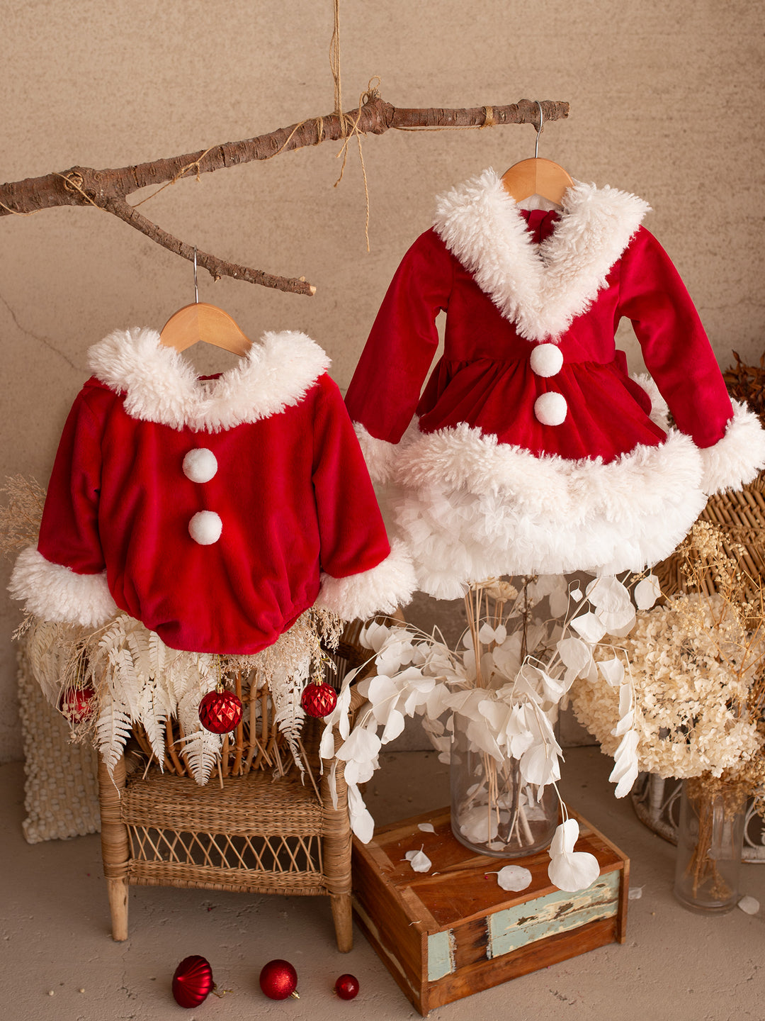 Santa Baby Romper hanging beside the matching She Came to Sleigh dress - Before & Ever Kids