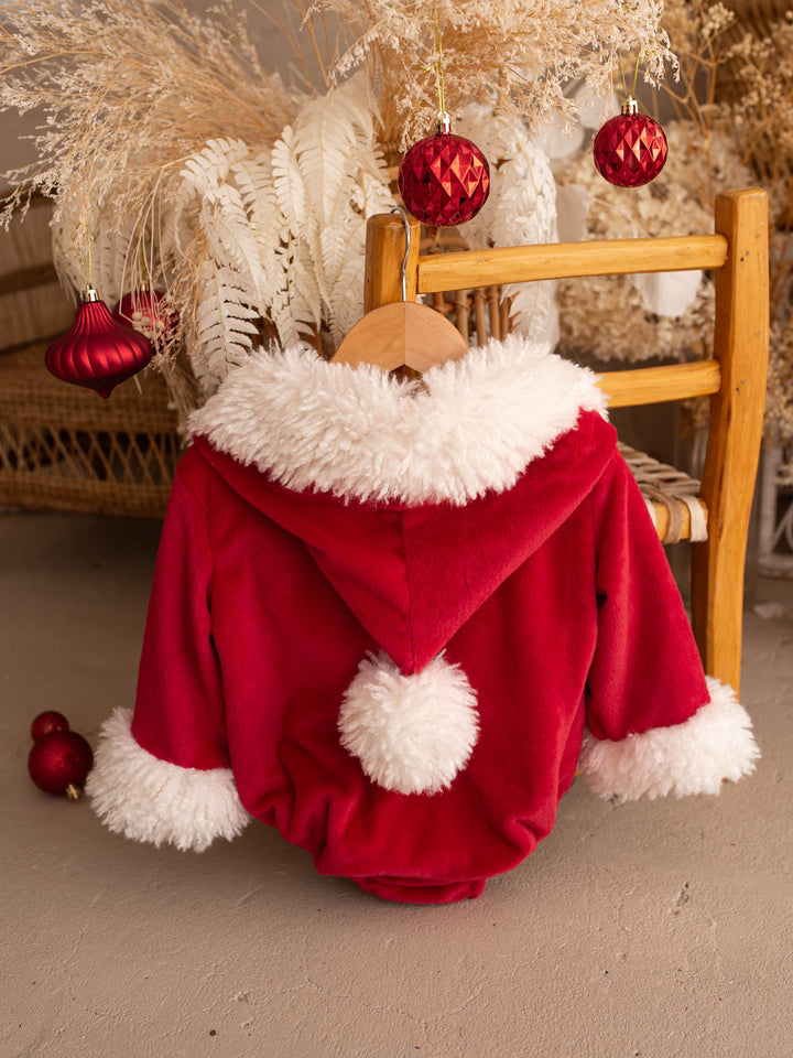 Santa Baby Romper back view on a wooden chair, pom-pom on the hood - Before & Ever Kids