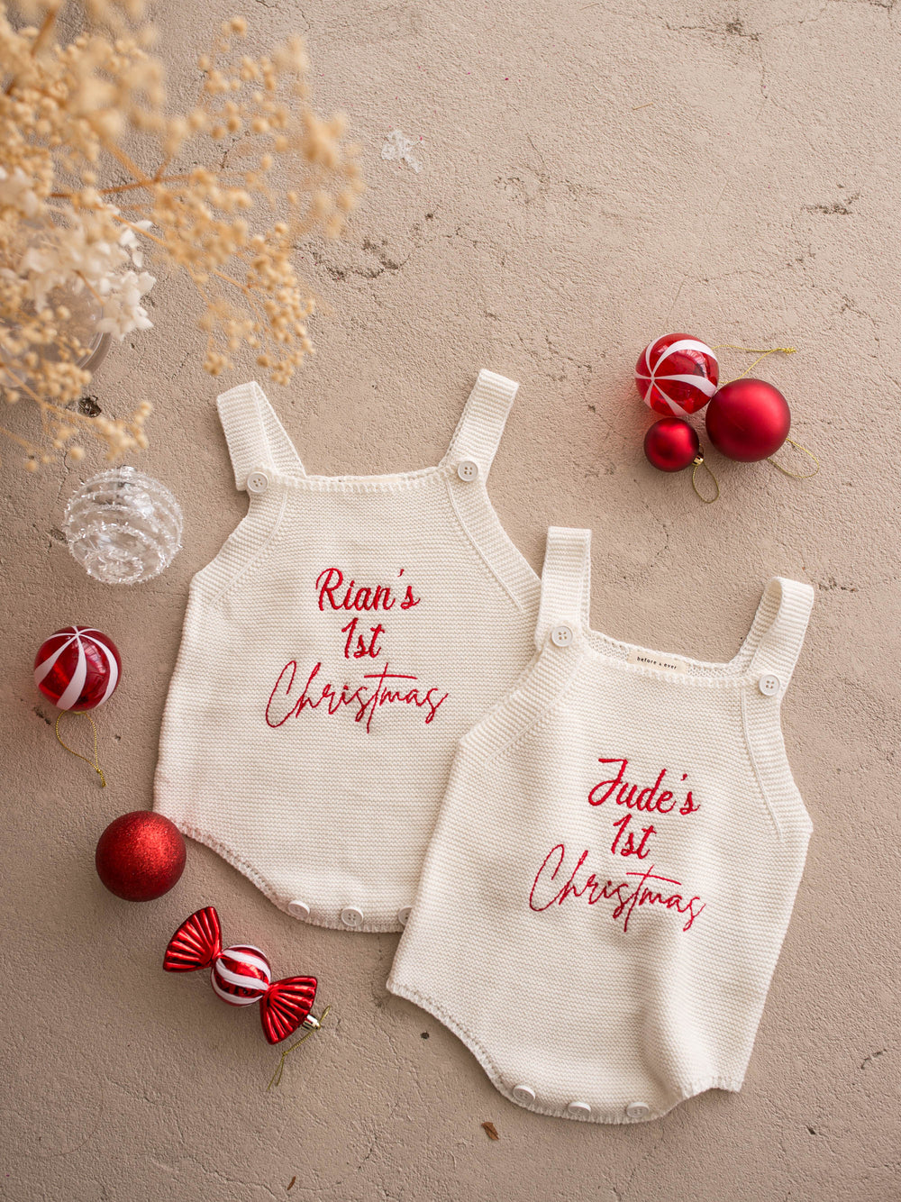 Say My Name Christmas Singlet Romper in milk cotton knit with a personalised name in red, two personalised rompers laid flat together - Before & Ever Kids