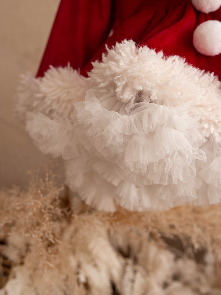 Close up of the white pom-poms and fluffy trim on the She Came to Sleigh dress - Before & Ever Kids