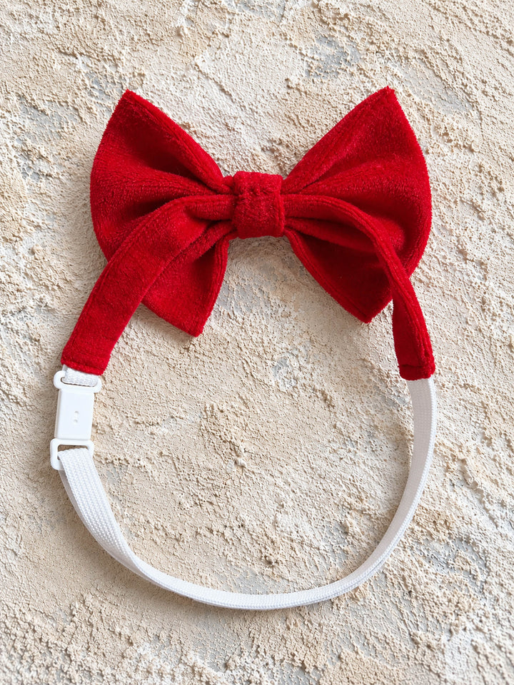 Velvet Bow Tie in red, the white elastic neck strap looped round, showing the adjuster and clip - Before & Ever Kids