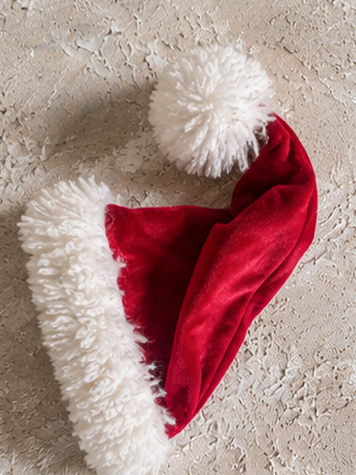 Velvet Santa Hat in deep red, laid flat on its side, showing the full length and pom-pom - Before & Ever Kids