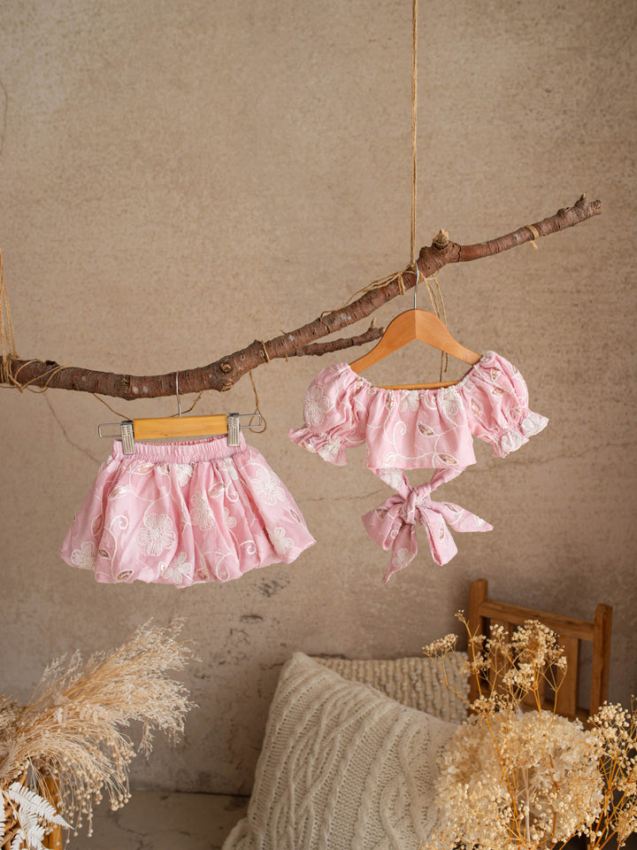 Where Summer Blooms baby pink baby girl set with white floral embroidery, gold sequins, puff sleeves and a bubble-hem skort.