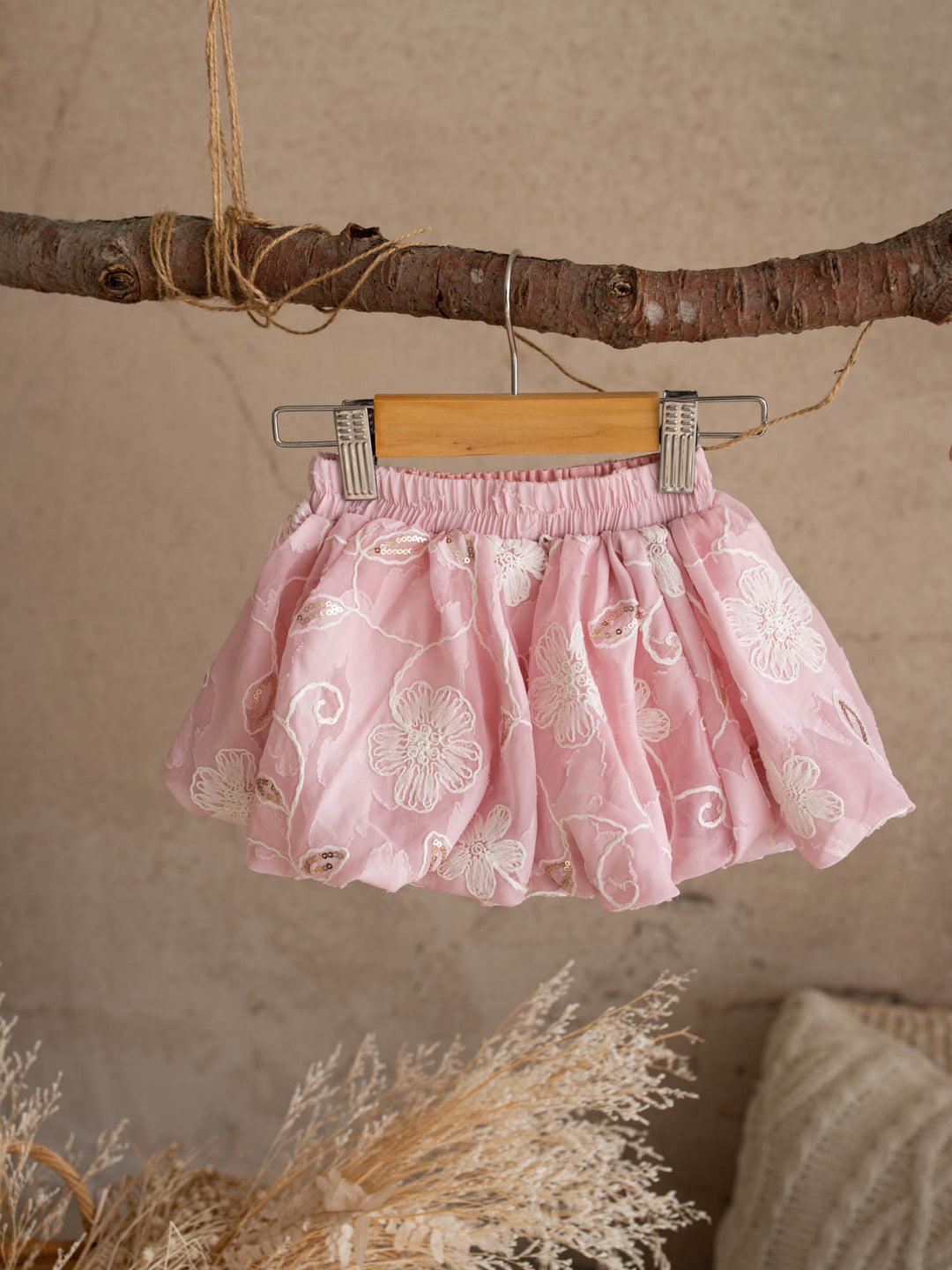 Where Summer Blooms baby pink baby girl set with white floral embroidery, gold sequins, puff sleeves and a bubble-hem skort.