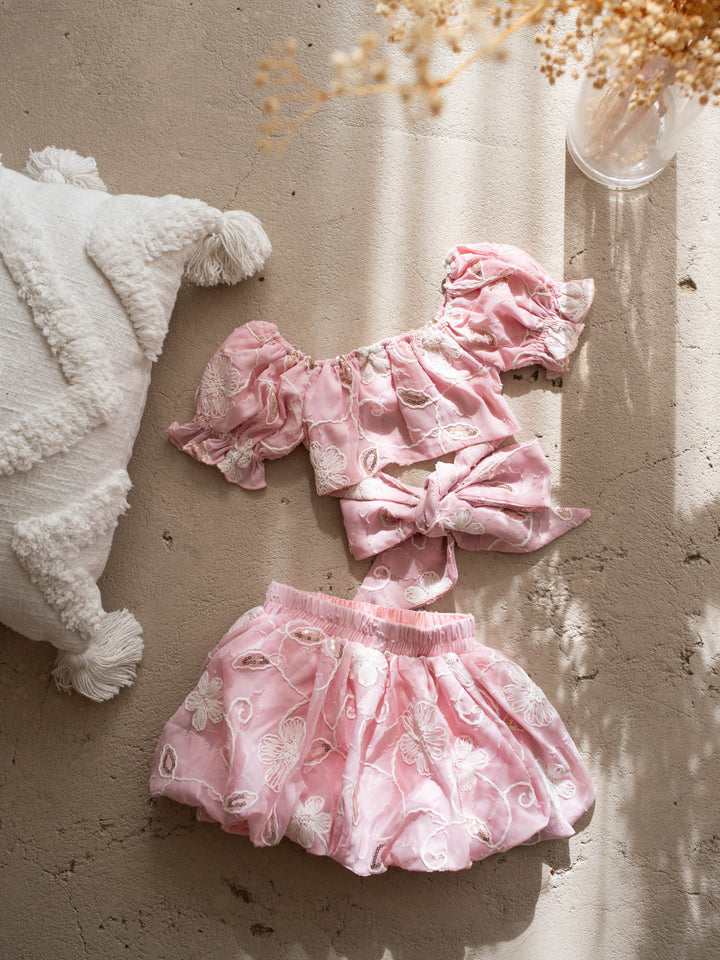 Where Summer Blooms baby pink baby girl set with white floral embroidery, gold sequins, puff sleeves and a bubble-hem skort.