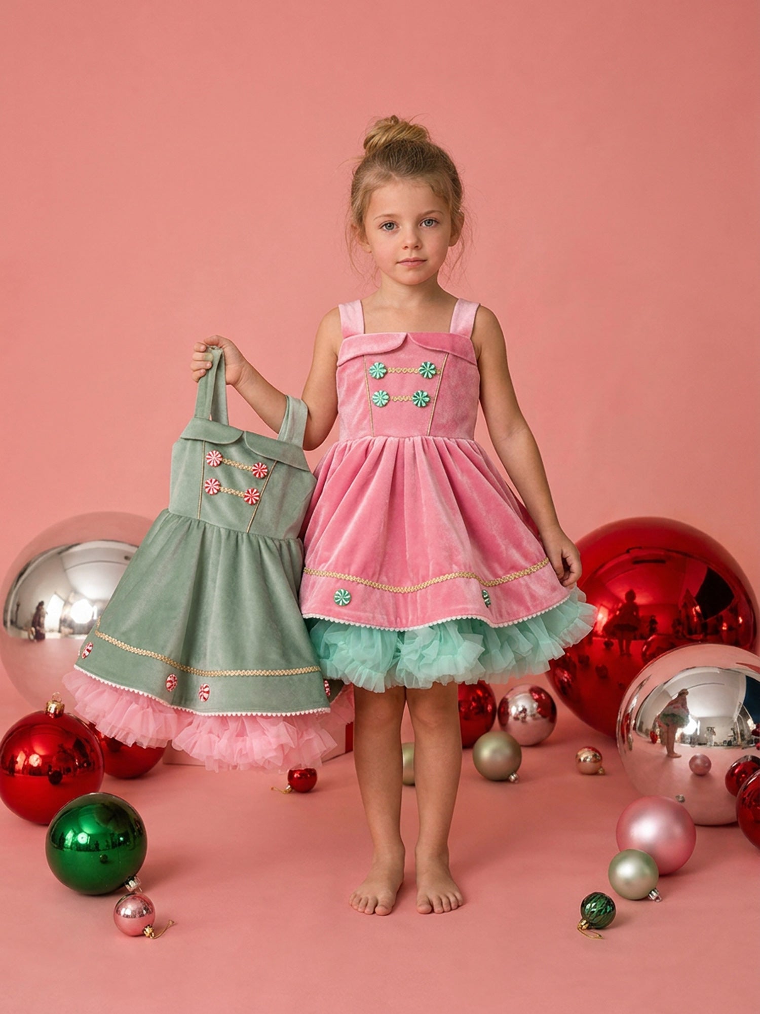 Two girls wearing the matching Merry Berry and Merry Mint Christmas dresses
